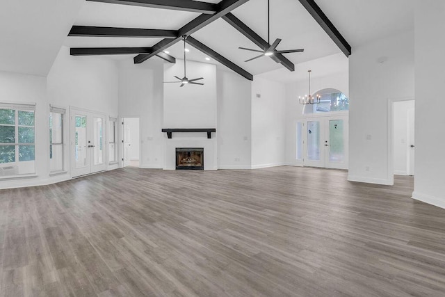1005 Shalimar Point Dr, Shalimar, FL 32579 - unfurnished living room featuring high vaulted ceiling, ceiling fan, a glass covered fireplace, a chandelier, and beamed ceiling