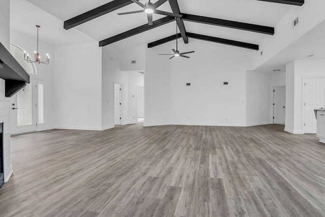 1005 Shalimar Point Dr, Shalimar, FL 32579 - unfurnished living room featuring ceiling fan, high vaulted ceiling, a chandelier, beamed ceiling, and wood finished floors