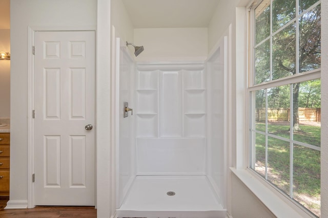 24 W Violet Ln, Defuniak Springs, FL 32433 - full bath with a stall shower, wood finished floors, and vanity