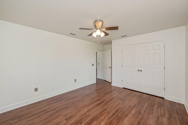 24 W Violet Ln, Defuniak Springs, FL 32433 - unfurnished bedroom with dark wood-type flooring, a closet, and a ceiling fan