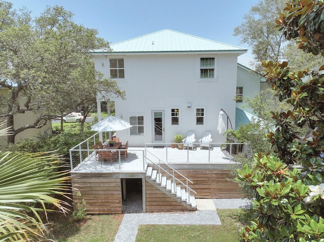 192 Lake Pointe Dr, Santa Rosa Beach, FL 32459 - rear view of house with stairway, stucco siding, and a metal roof