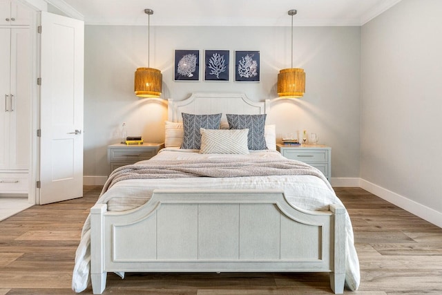 192 Lake Pointe Dr, Santa Rosa Beach, FL 32459 - bedroom featuring ornamental molding and wood finished floors