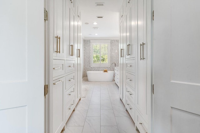 192 Lake Pointe Dr, Santa Rosa Beach, FL 32459 - bathroom featuring a freestanding bath, marble finish flooring, and recessed lighting