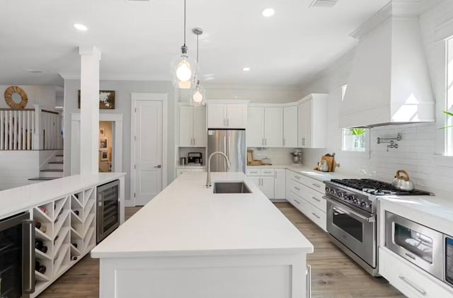 192 Lake Pointe Dr, Santa Rosa Beach, FL 32459 - kitchen featuring stainless steel appliances, beverage cooler, custom range hood, crown molding, and decorative backsplash