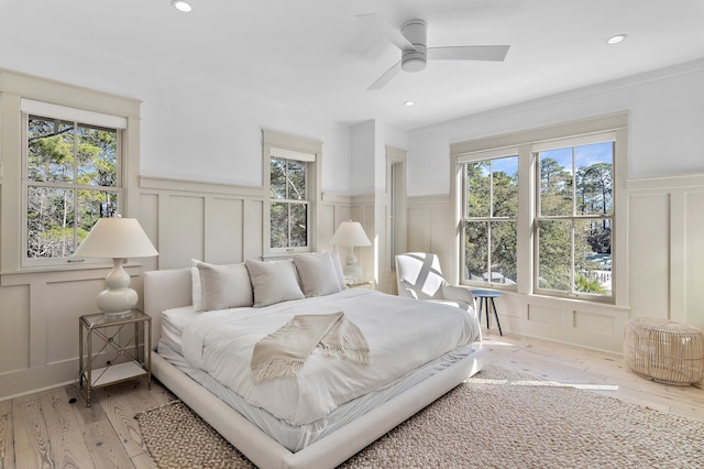 395 Tumblehome Way, Santa Rosa Beach, FL 32459 - bedroom with a decorative wall, a wainscoted wall, light wood-style flooring, recessed lighting, and ceiling fan