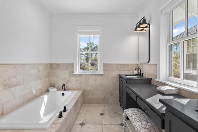 395 Tumblehome Way, Santa Rosa Beach, FL 32459 - full bath with double vanity, a bath, ornamental molding, a wainscoted wall, and tile walls