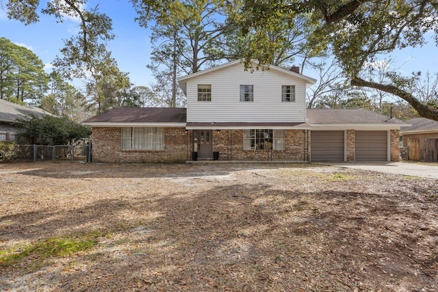 1011 Creel St, Fort Walton Beach, FL 32547 - view of front of property featuring brick siding, a garage, driveway, and roof with shingles