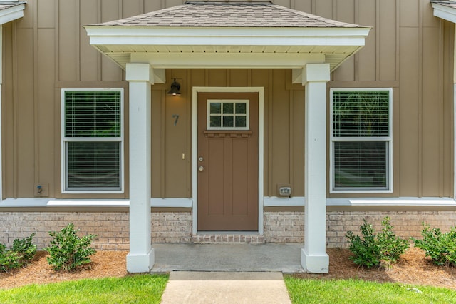 400 Mattie M Kelly Blvd Unit 7, Destin, FL 32541 - property entrance featuring board and batten siding, roof with shingles, and covered porch