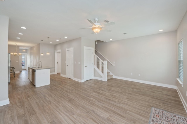 400 Mattie M Kelly Blvd Unit 7, Destin, FL 32541 - unfurnished living room with stairway, light wood-type flooring, recessed lighting, and ceiling fan
