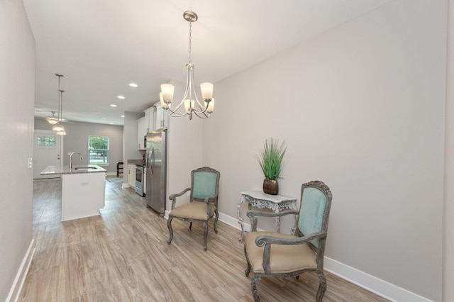 400 Mattie M Kelly Blvd Unit 7, Destin, FL 32541 - sitting room with light wood-style floors, a chandelier, and recessed lighting