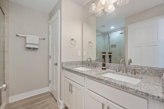 400 Mattie M Kelly Blvd Unit 7, Destin, FL 32541 - bathroom featuring double vanity, a stall shower, and wood finished floors