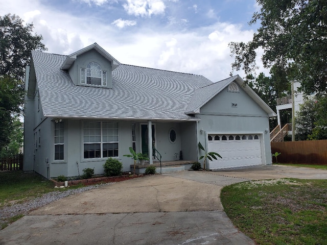 2969 Laurel Dr, Gulf Breeze, FL 32563 - view of front of house featuring a porch, driveway, roof with shingles, and a garage