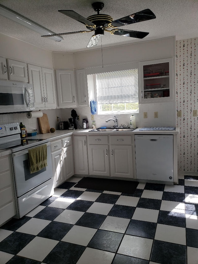 2969 Laurel Dr, Gulf Breeze, FL 32563 - kitchen featuring white appliances, dark flooring, white cabinetry, a textured ceiling, and ceiling fan