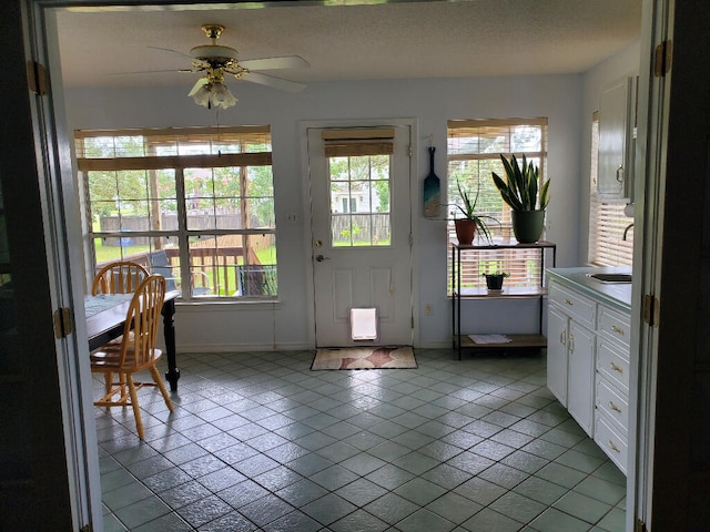 2969 Laurel Dr, Gulf Breeze, FL 32563 - doorway to outside with a ceiling fan, light tile patterned floors, and a textured ceiling