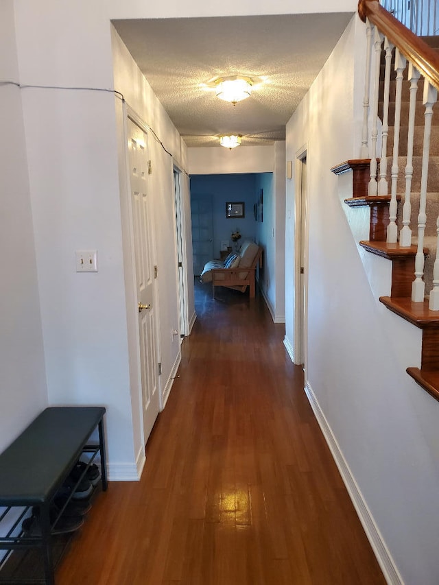 2969 Laurel Dr, Gulf Breeze, FL 32563 - hallway with stairs, wood finished floors, and a textured ceiling