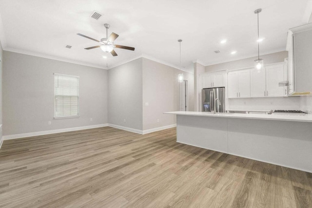54 Kara Lake Dr, Santa Rosa Beach, FL 32459 - kitchen featuring crown molding, light countertops, light wood-style flooring, white cabinetry, and ceiling fan