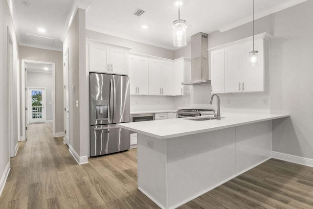 54 Kara Lake Dr, Santa Rosa Beach, FL 32459 - kitchen with stainless steel fridge with ice dispenser, wall chimney exhaust hood, a peninsula, light countertops, and white cabinetry