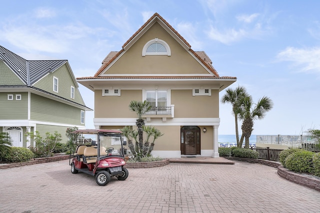 2905 Scenic Gulf Dr, Miramar Beach, FL 32550 - view of front of house with stucco siding, a balcony, and a tiled roof
