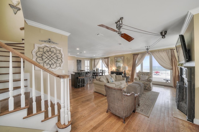 2905 Scenic Gulf Dr, Miramar Beach, FL 32550 - living area featuring ornamental molding, ceiling fan, stairs, light wood-style flooring, and recessed lighting
