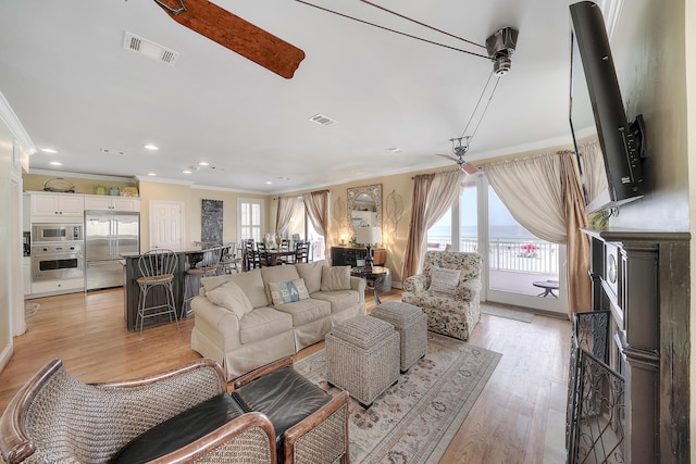 2905 Scenic Gulf Dr, Miramar Beach, FL 32550 - living room featuring ornamental molding, light wood finished floors, and recessed lighting