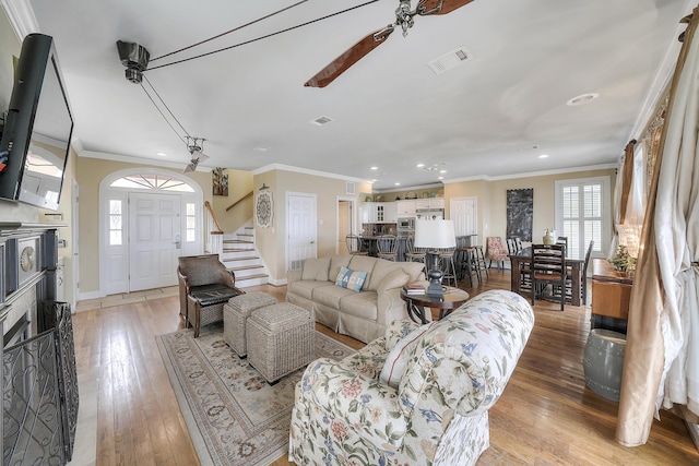 2905 Scenic Gulf Dr, Miramar Beach, FL 32550 - living area featuring recessed lighting, stairs, plenty of natural light, light wood-style flooring, and ornamental molding
