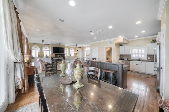 2905 Scenic Gulf Dr, Miramar Beach, FL 32550 - dining area with crown molding, recessed lighting, and light wood-type flooring