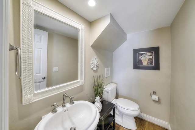 2905 Scenic Gulf Dr, Miramar Beach, FL 32550 - half bathroom featuring a sink and wood finished floors