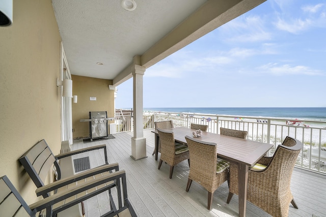 2905 Scenic Gulf Dr, Miramar Beach, FL 32550 - balcony featuring grilling area, a view of the beach, outdoor dining area, and a deck with water view