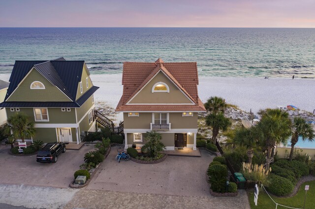 2905 Scenic Gulf Dr, Miramar Beach, FL 32550 - view of front of home featuring view of water and beach, decorative driveway, stucco siding, and stairway