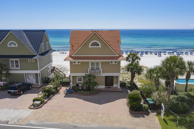 2905 Scenic Gulf Dr, Miramar Beach, FL 32550 - view of front of property featuring stucco siding, view of water and beach, and decorative driveway