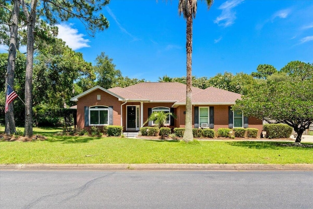 2050 Biscayne Blvd, Navarre, FL 32566 - ranch-style home featuring a front lawn and brick siding