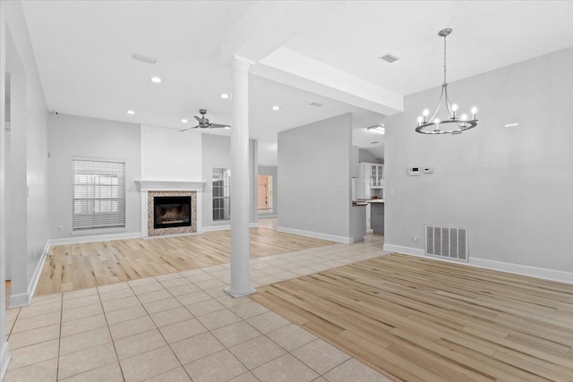 2050 Biscayne Blvd, Navarre, FL 32566 - unfurnished living room with a ceiling fan, light wood finished floors, a fireplace, recessed lighting, and a chandelier