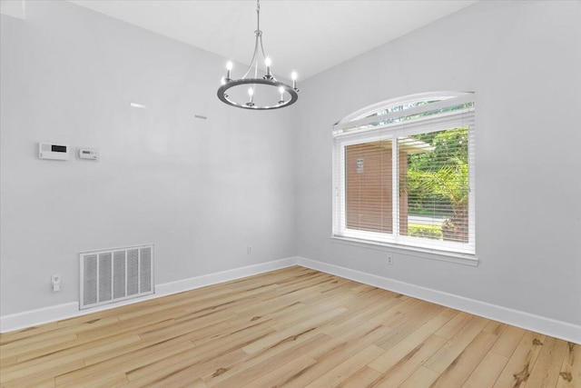 2050 Biscayne Blvd, Navarre, FL 32566 - unfurnished room with a chandelier and wood finished floors