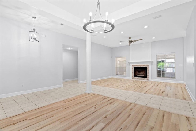 2050 Biscayne Blvd, Navarre, FL 32566 - unfurnished living room with a chandelier, light wood-type flooring, a ceiling fan, a fireplace, and recessed lighting