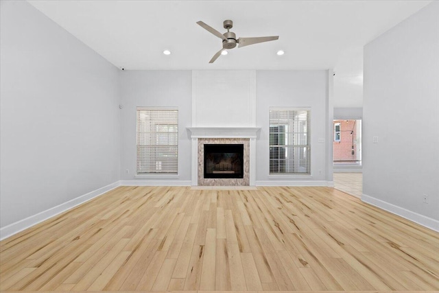 2050 Biscayne Blvd, Navarre, FL 32566 - unfurnished living room with light wood-type flooring, a ceiling fan, a fireplace, healthy amount of natural light, and recessed lighting