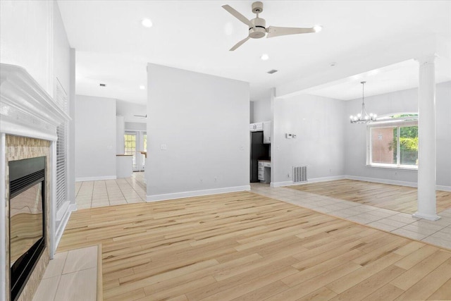 2050 Biscayne Blvd, Navarre, FL 32566 - unfurnished living room featuring ceiling fan, light wood finished floors, plenty of natural light, a tiled fireplace, and recessed lighting