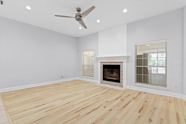 2050 Biscayne Blvd, Navarre, FL 32566 - unfurnished living room with light wood-type flooring, a ceiling fan, a tiled fireplace, and recessed lighting
