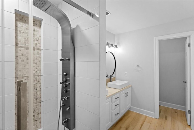 2050 Biscayne Blvd, Navarre, FL 32566 - bathroom featuring wood finished floors, double vanity, and tiled shower