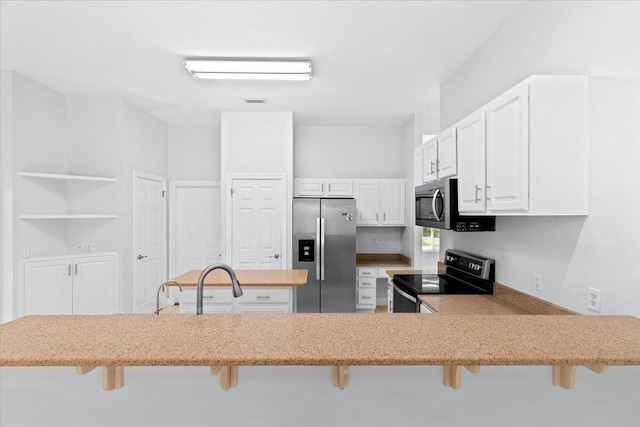 2050 Biscayne Blvd, Navarre, FL 32566 - kitchen with stainless steel appliances, a breakfast bar, light stone counters, and white cabinetry