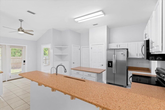 2050 Biscayne Blvd, Navarre, FL 32566 - kitchen with appliances with stainless steel finishes, ceiling fan, vaulted ceiling, white cabinetry, and a center island