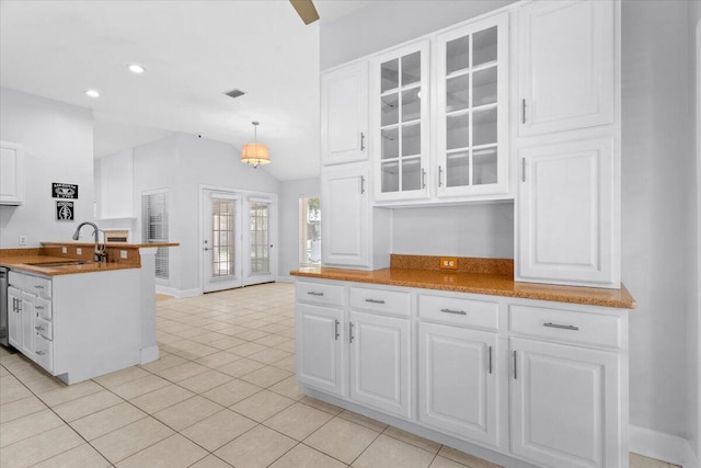 2050 Biscayne Blvd, Navarre, FL 32566 - kitchen featuring glass insert cabinets, white cabinetry, light tile patterned floors, vaulted ceiling, and pendant lighting
