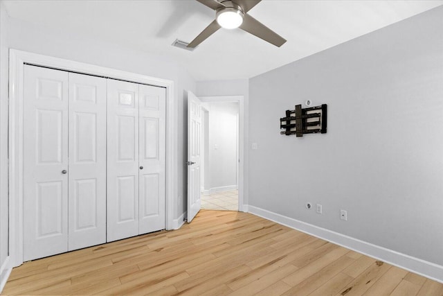 2050 Biscayne Blvd, Navarre, FL 32566 - unfurnished bedroom featuring light wood-style flooring, a closet, and a ceiling fan