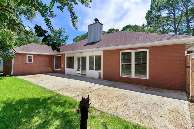 2050 Biscayne Blvd, Navarre, FL 32566 - back of property featuring a chimney, a patio, a yard, and brick siding