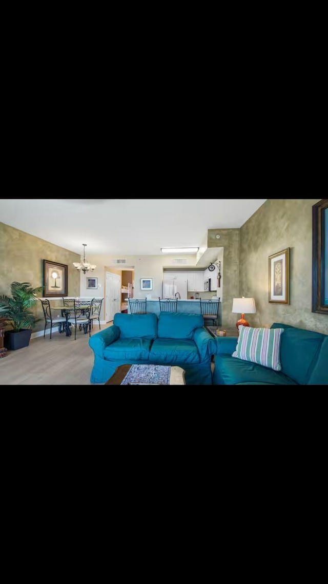 17757 Front Beach Rd Unit 2204D, Panama City Beach, FL 32413 - living room featuring a chandelier and wood finished floors