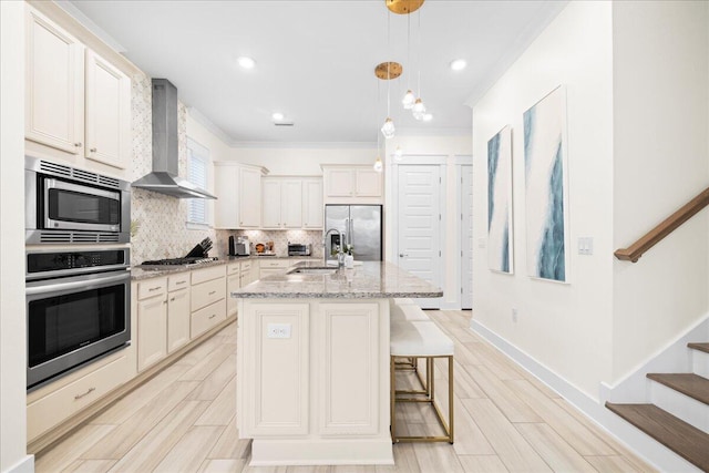 73 Dune Comet Ln Unit B, Inlet Beach, FL 32461 - kitchen featuring stainless steel appliances, wall chimney range hood, tasteful backsplash, crown molding, and a center island with sink