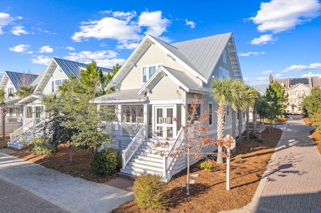 49 Clipper St, Inlet Beach, FL 32461 - view of front of house featuring stairway, a metal roof, a porch, and french doors