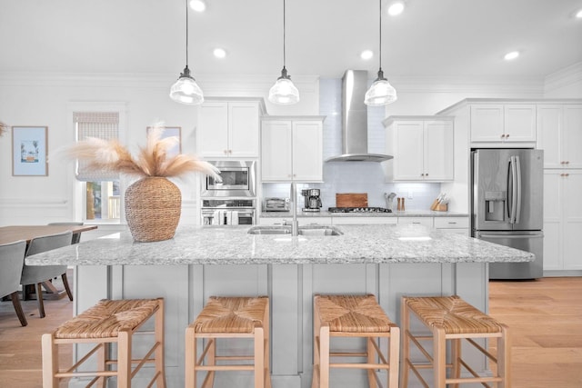 49 Clipper St, Inlet Beach, FL 32461 - kitchen with appliances with stainless steel finishes, wall chimney exhaust hood, ornamental molding, a breakfast bar area, and tasteful backsplash