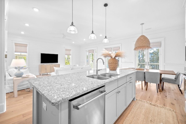 49 Clipper St, Inlet Beach, FL 32461 - kitchen with dishwasher, crown molding, light wood-style floors, a center island with sink, and light stone countertops