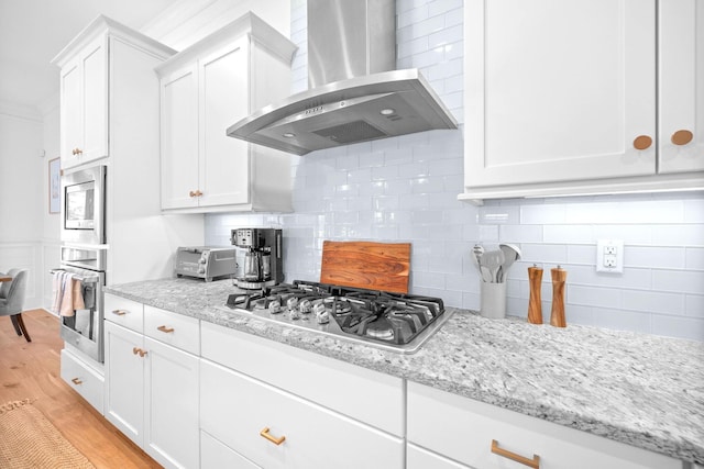 49 Clipper St, Inlet Beach, FL 32461 - kitchen with wall chimney exhaust hood, appliances with stainless steel finishes, white cabinets, backsplash, and light wood-style floors