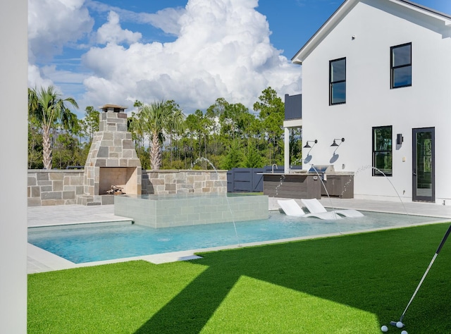 83 Norman Ct, Inlet Beach, FL 32461 - outdoor pool featuring an outdoor stone fireplace, an outdoor kitchen, a yard, and a patio area
